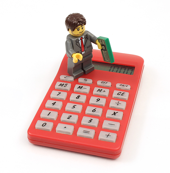 LEGO® Minifigure Standing On Top Of A Calculator